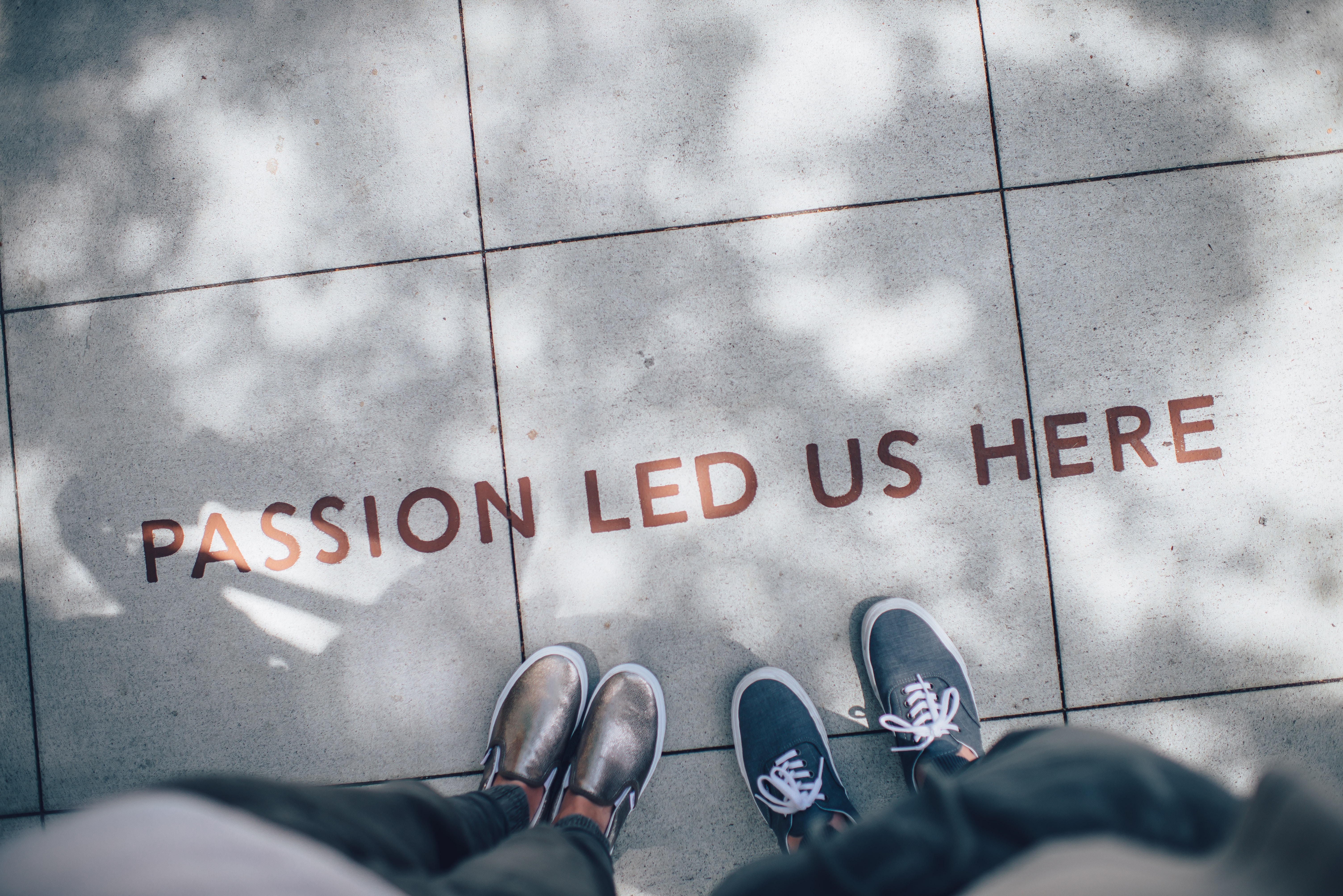 passion led us here wrote on sidewalk picture